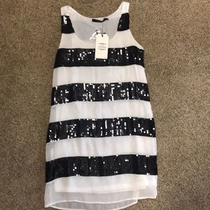 White with a black sequins dress.